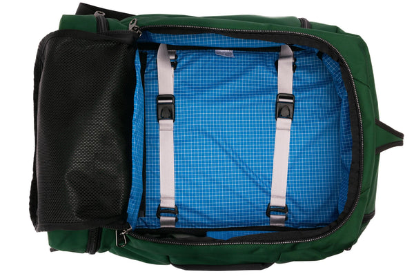 An open Techonaut 45 with a Wilderness (forest green) exterior and a Island (blue) interior.